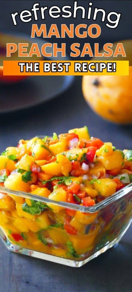 Mango peach salsa in glass bowl with bell peppers, cilantro, red onions with text 