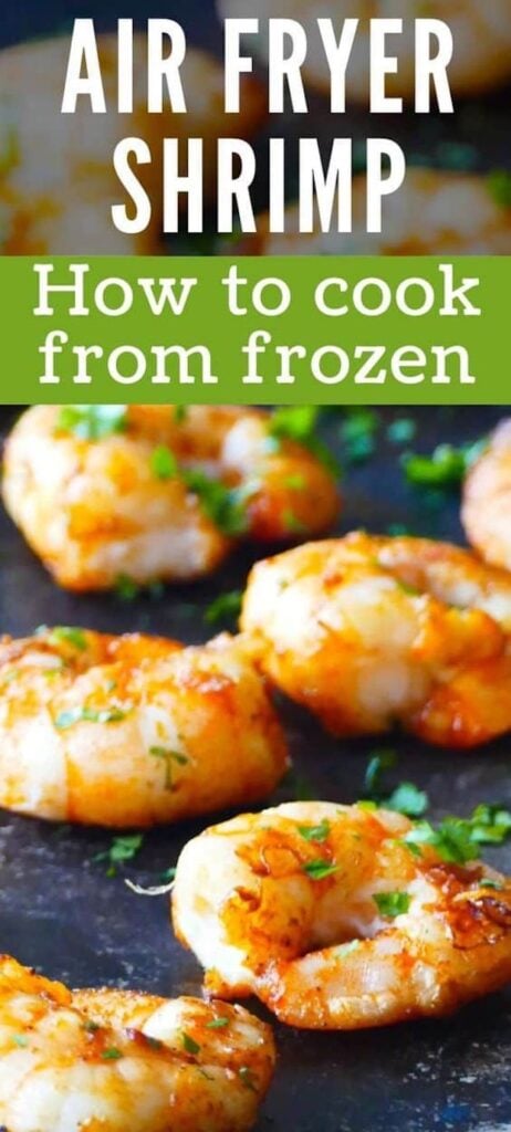 Cooked spiced shrimp arranged on a dark background with parsley garnish with text "air fryer frozen shrimp".