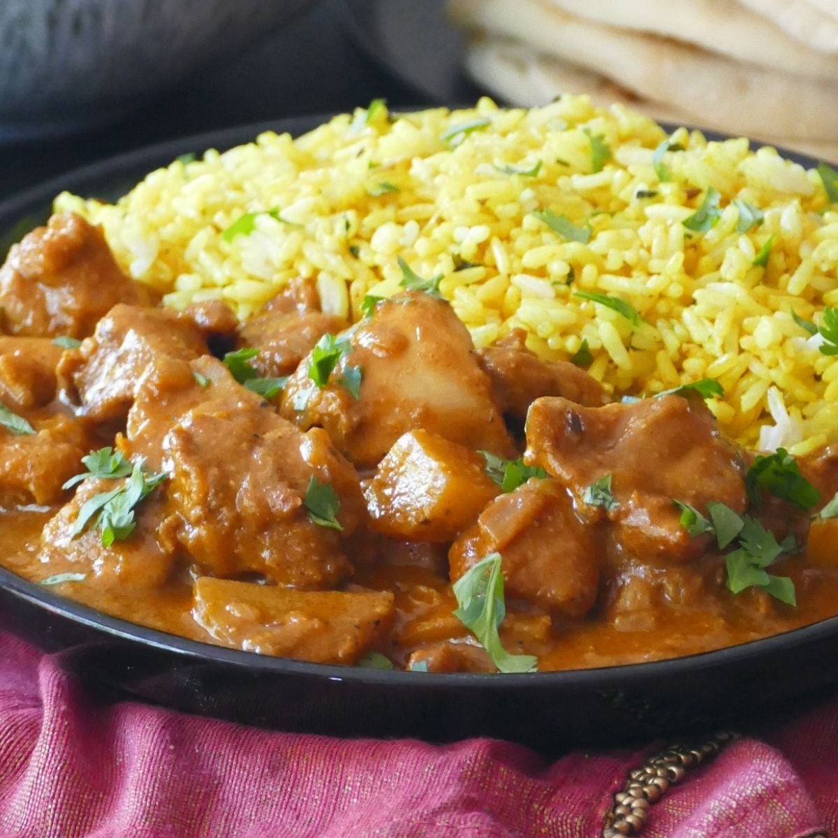 Chicken curry and rice on plate.