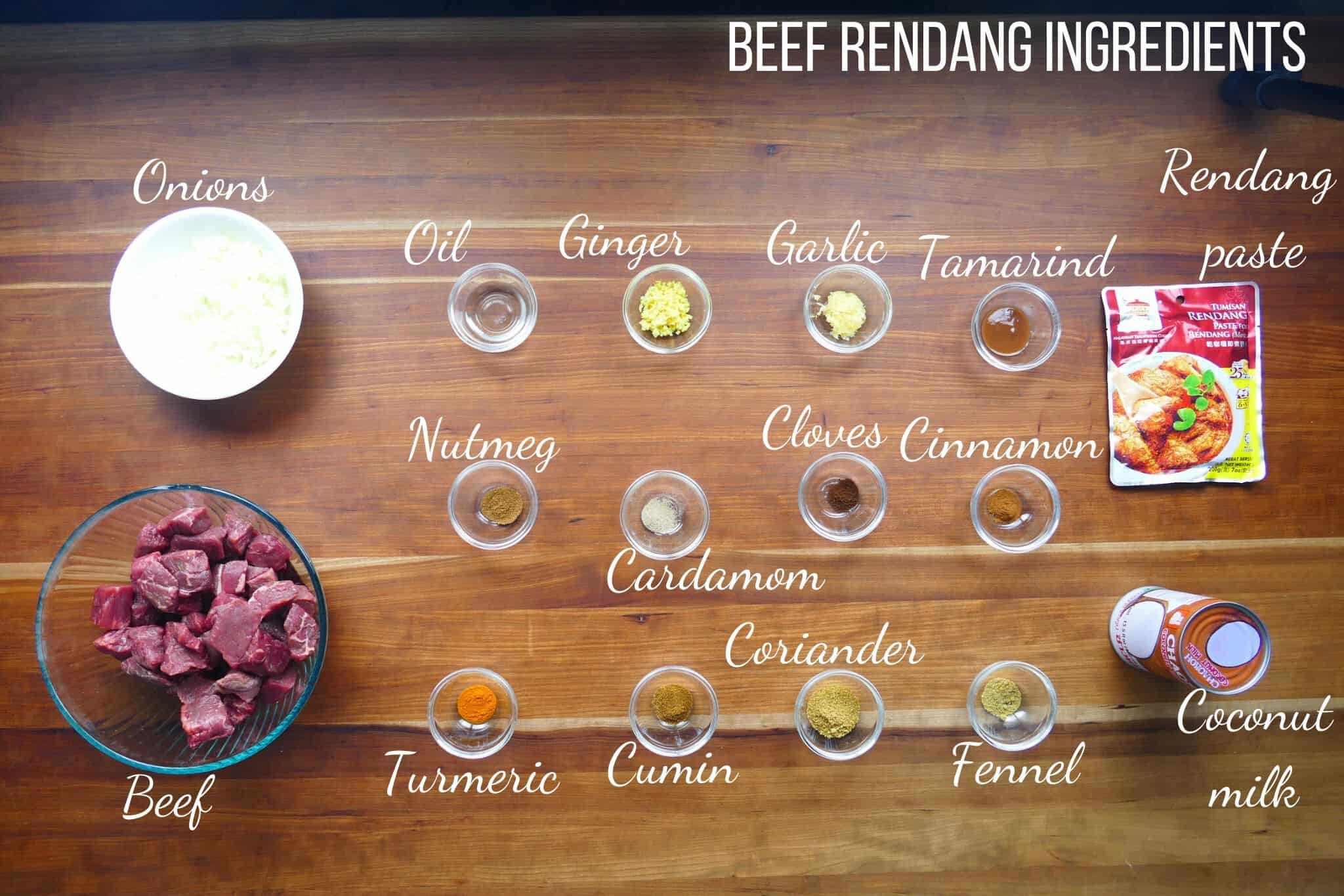 Beef rendang Ingredients on wood counter.