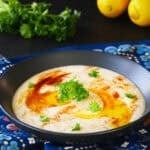 Bowl with mutabal or baba ganoush with parsley and olive oil on top.