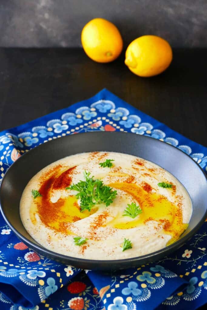 Bowl with mutabal or baba ganoush with parsley and olive oil on top.