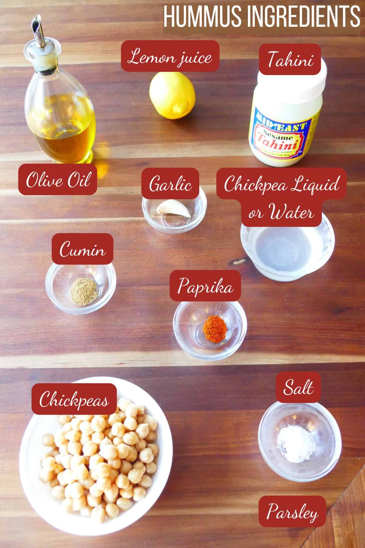 Hummus ingredients: olive oil, lemon juice, tahini, cumin, garlic, chickpea liquid, paprika, chickpeas, salt, parsley.