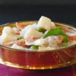 Kerala vegetable stew with potatoes carrots, curry leaves in a creamy white sauce.