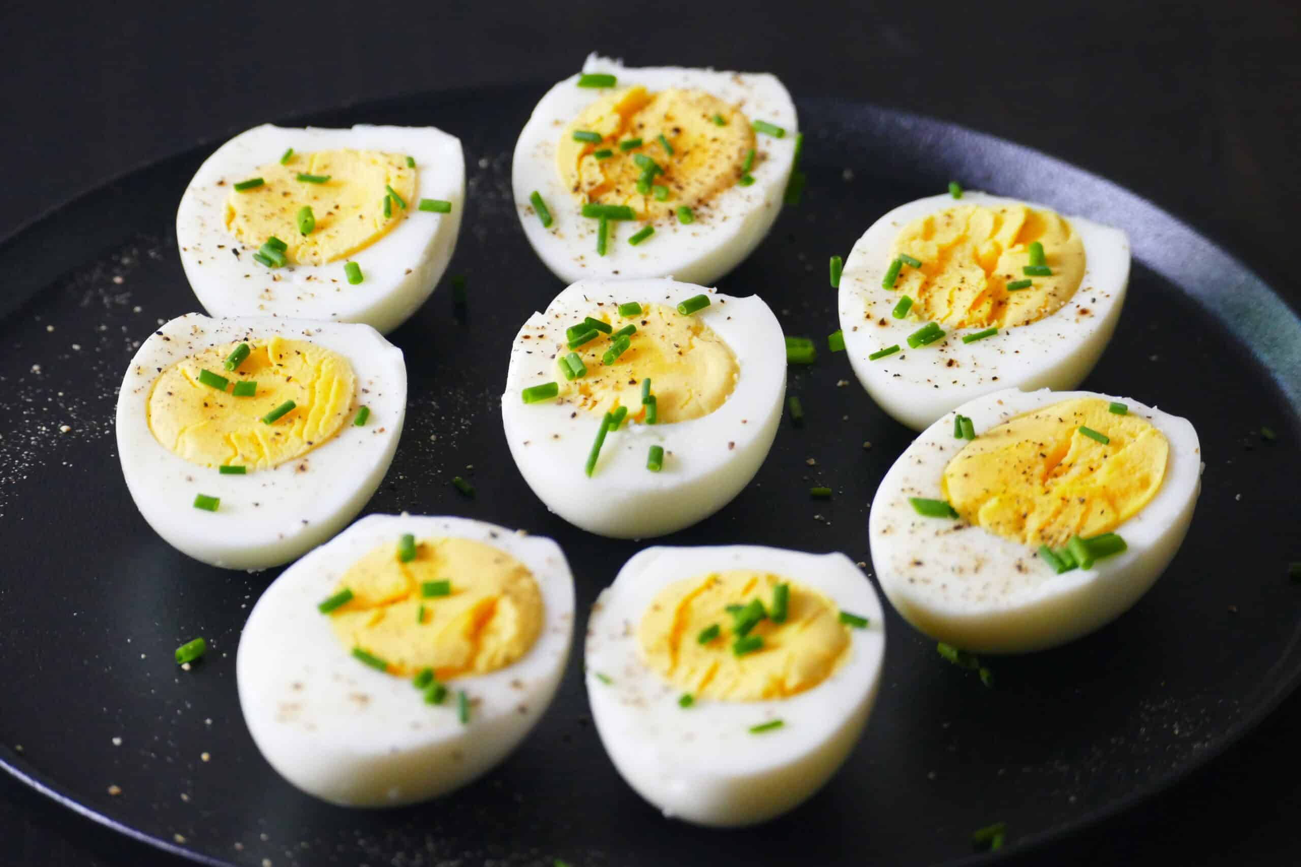 Eight halved Instant Pot 1-minute hard boiled eggs on plate.