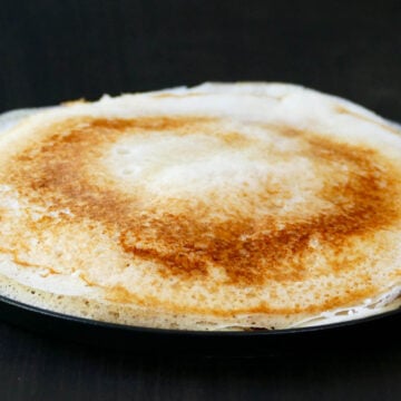 Dosa stacked on a plate.