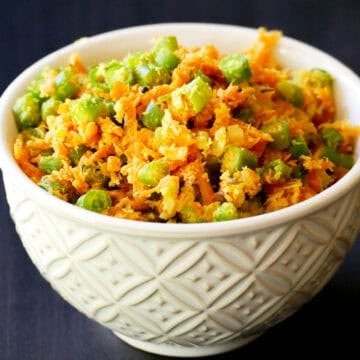 Carrots and green beans thoran in a white bowl.