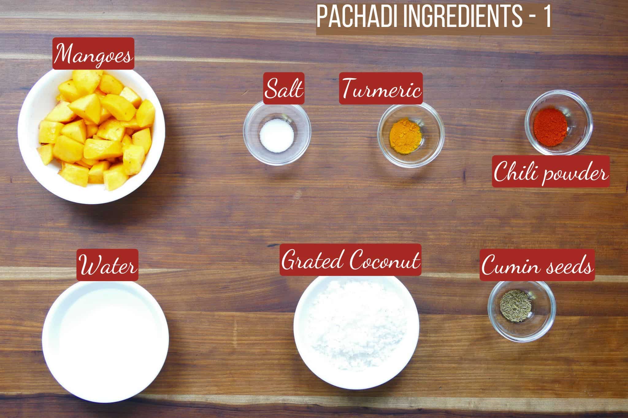 Mango pachadi ingredients on wooden counter - part 1.