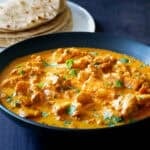 Instant Pot Chicken Tikka Masala in black bowl with rotis.